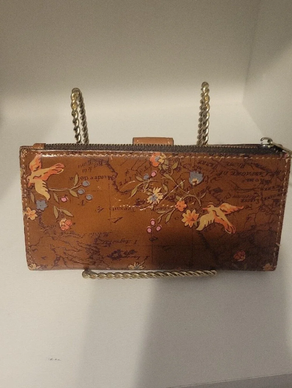 Brown leather Patricia Nash bifold wallet featuring an artistic vintage map back